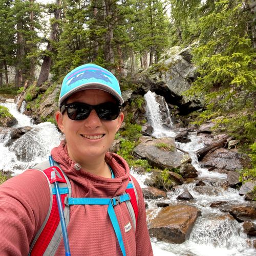Hiker infront of waterfall